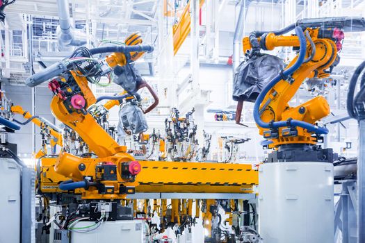 robotic arms in a car plant