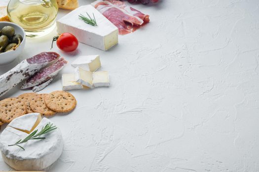 Assortment of cheese and meat appetizers set, on white background with copy space for text