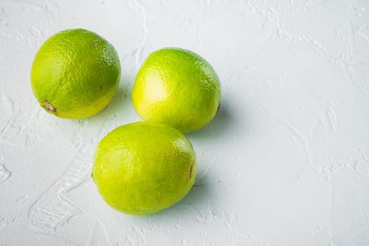 Whole green lime set, on white background with copy space for text
