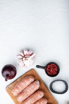Homemade pork sausages, top view with space for text, on white background.