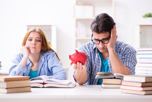 Two students checking savings to pay for education