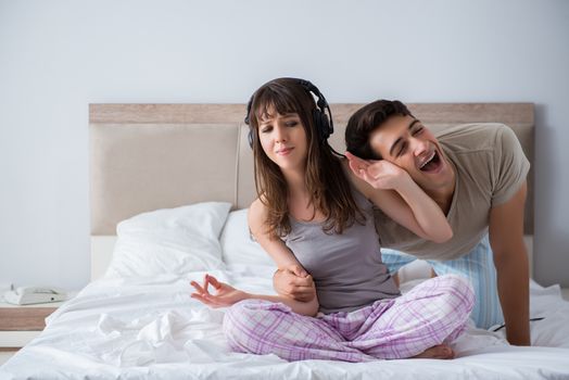 Young family meditating in the bed bedroom