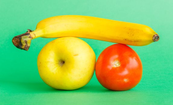 a banana, an apple and a tomato