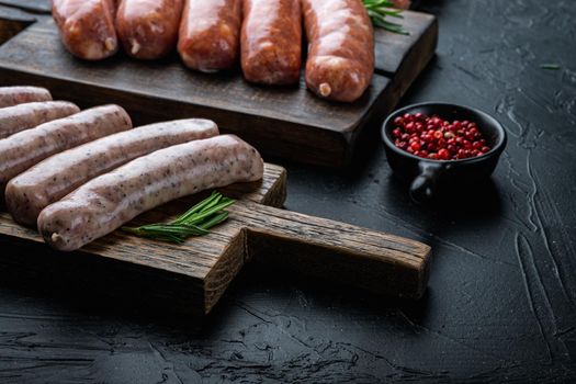 Traditional chicken sausages, on black background.