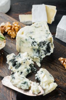Tasty blue cheese set, on dark wooden background