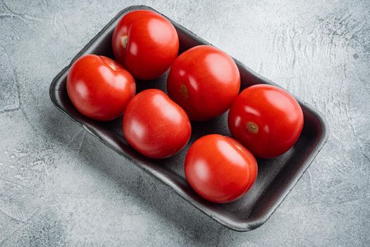 Red tomatoes, on gray background