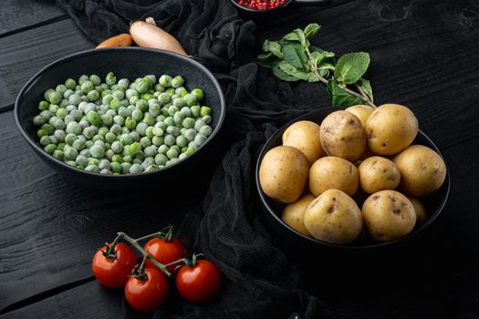 Mashed potatoes ingredient with green pea and mint, on black wooden background