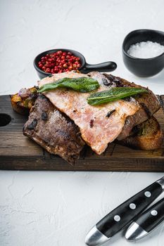 Liver bacon and onions on bread cooked meal served on board, on white background.