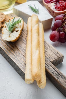 Breadsticks, with olive oil, on white background