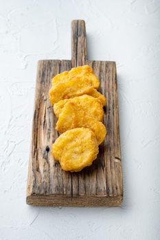 Homemade chicken nuggets fried on white background.