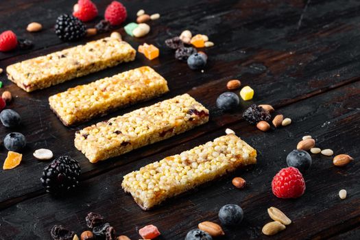 Set of healthy granola, muesli and cereal bars, on wooden table