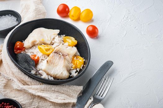 Tilapia fish with basmati rice and cherry tomatoes, in bowl, on white background with copy space for text