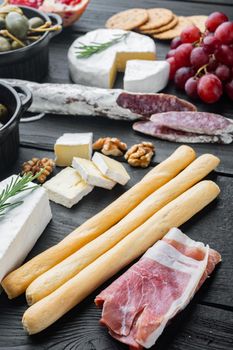 Breadsticks, with olive oil, on black wooden table