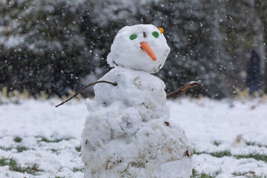 Madrid, Spain - January 08, 2021: Snowmen made by some kids, in the Buen Retiro park in Madrid, in the middle of a snowy day, due to a wave of polar cold.