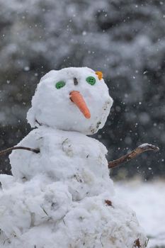 Madrid, Spain - January 08, 2021: Snowmen made by some kids, in the Buen Retiro park in Madrid, in the middle of a snowy day, due to a wave of polar cold.