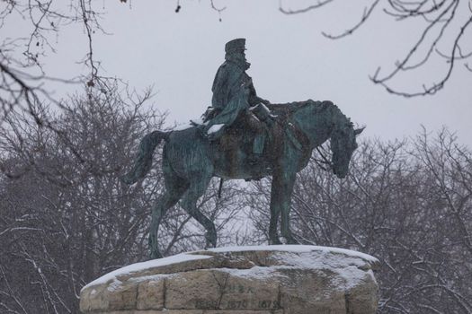 Madrid, Spain - January 08, 2021: Monument to General Martinez Campos in Retiro park in Madrid, in the middle of a snowy day, due to a wave of polar cold.