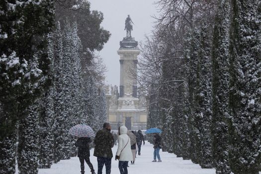 Madrid, Spain - January 08, 2021: Monument to Alfonso XII in Retiro park, Madrid, in the middle of a snowy day, due to a wave of polar cold.