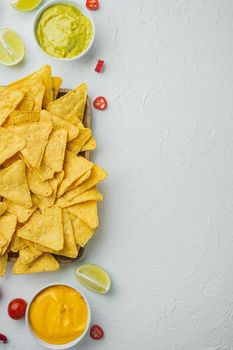 Corn tortilla chips nachos and dip sauce, on white background, top view or flat lay with copy space for text