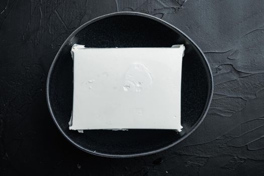 Traditional greek feta cheese set, on black background, top view