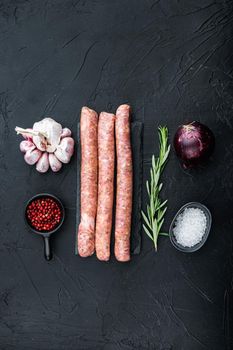 Traditional mest sausages, flat lay, on black background.