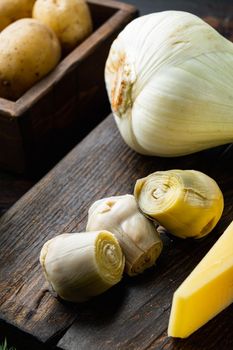 Artichoke hearts marinated with olive oil, on old wooden table