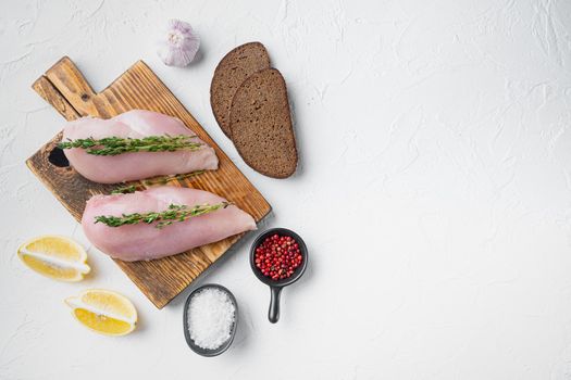 Crumbed uncooked chicken breasts ingredient on white background, flat lay with space for text