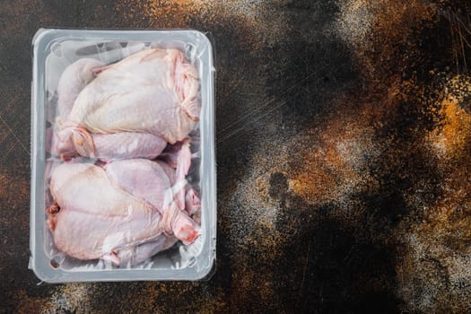Whole raw chicken meat package, on old rustic background, top view with copy space for text
