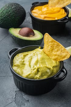Traditional mexican homemade guacamole sauce in bowl, on gray background