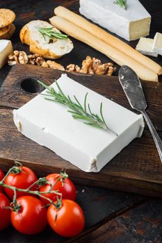 Traditional greek feta cheese set, on dark wooden background