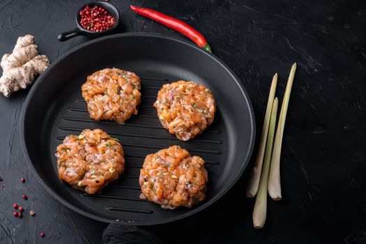 Quick asian raw fishcake, on black textured background