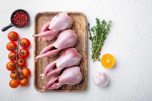 Homemade eco friendly raw quail, top view, on white textured background with copy space