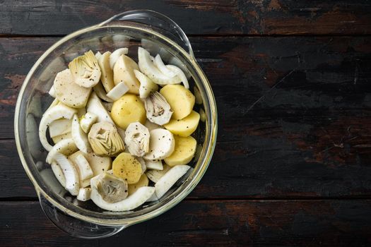 Potato and artichoke with fennel for baking raw ingredients, on old wooden table, flat lay with space for text