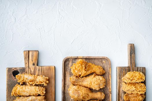 Southern fried chicken cuts on white background, flat lay, with space for text.