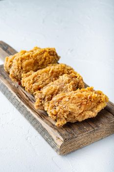 Spicy deep fried breaded chicken wings cuts on white background, with space for text.