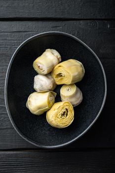 Artichoke hearts set, on black wooden table, flat lay
