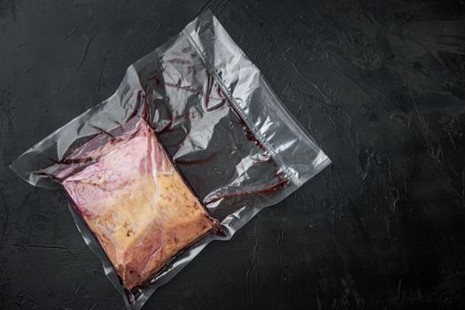 Top sirloin beef big cut in plastic pack, on black background, top view, with copy space for text