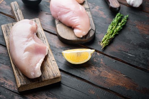 Crispy garlicky chicken raw ingredient, on dark wooden background with copy space