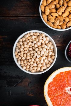 Chickpea in white bowl, flat lay on dark wooden background.