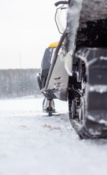 The back of the snowmobile in winter. Riding in the snow on a snowmobile. Rear suspension of a snowmobile