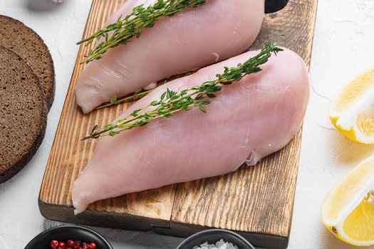 Crumbed uncooked chicken breasts ingredient on white background