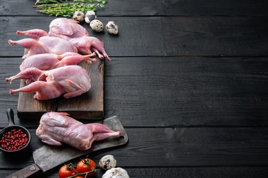 Fresh raw meat quails with herb, on black wooden background with space for text