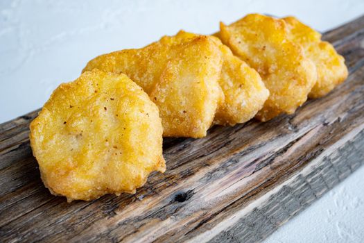 Fried crispy chicken nuggets meat on white background.