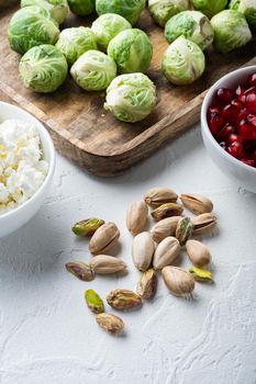 Shelled, unsalted pistachios, on white textured background