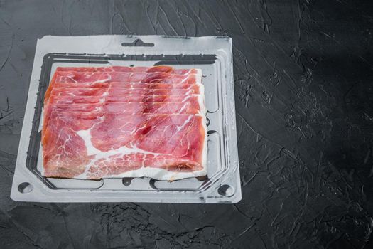 Heap of jamon slices set, on black background with copy space for text