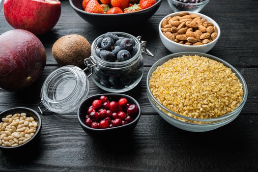 Healthy food and clean eating selection, on black wooden background.