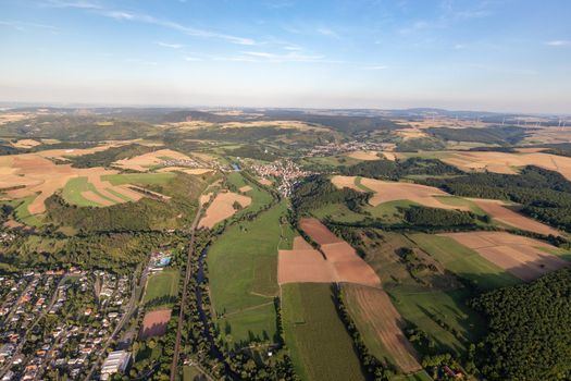 Aerial view at a landscape in Germany, Rhineland Palatinate near Bad Sobernheim with the river Nahe, meadow, farmland, forest, hills, mountains 