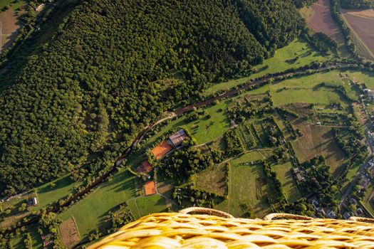 Aerial view out of a ballon basket at a landscape in Germany, Rhineland Palatinate near Bad Sobernheim with the river Nahe, meadow, farmland, forest, hills, mountains 