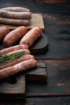Traditional beef sausages, on old dark wooden background.