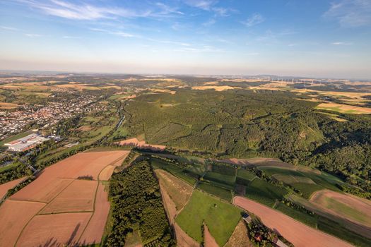 Aerial view at a landscape in Germany, Rhineland Palatinate near Bad Sobernheim with the river Nahe, meadow, farmland, forest, hills, mountains 