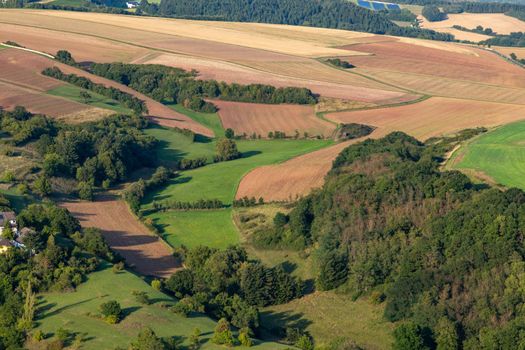 Aerial view at a landscape in Germany, Rhineland Palatinate near Bad Sobernheim with  meadow, farmland, forest, hills, mountains 